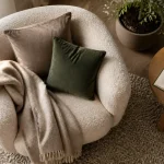 Coin cocooning salon près de la fenêtre, fauteuil bouclette et plaid